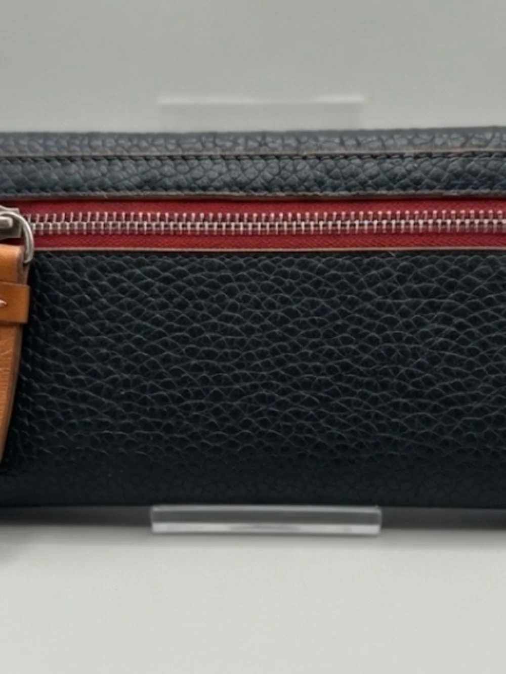 3 1/2”. X. 7”.  pebble-grain leather Dooney & Bourke Continental Clutch